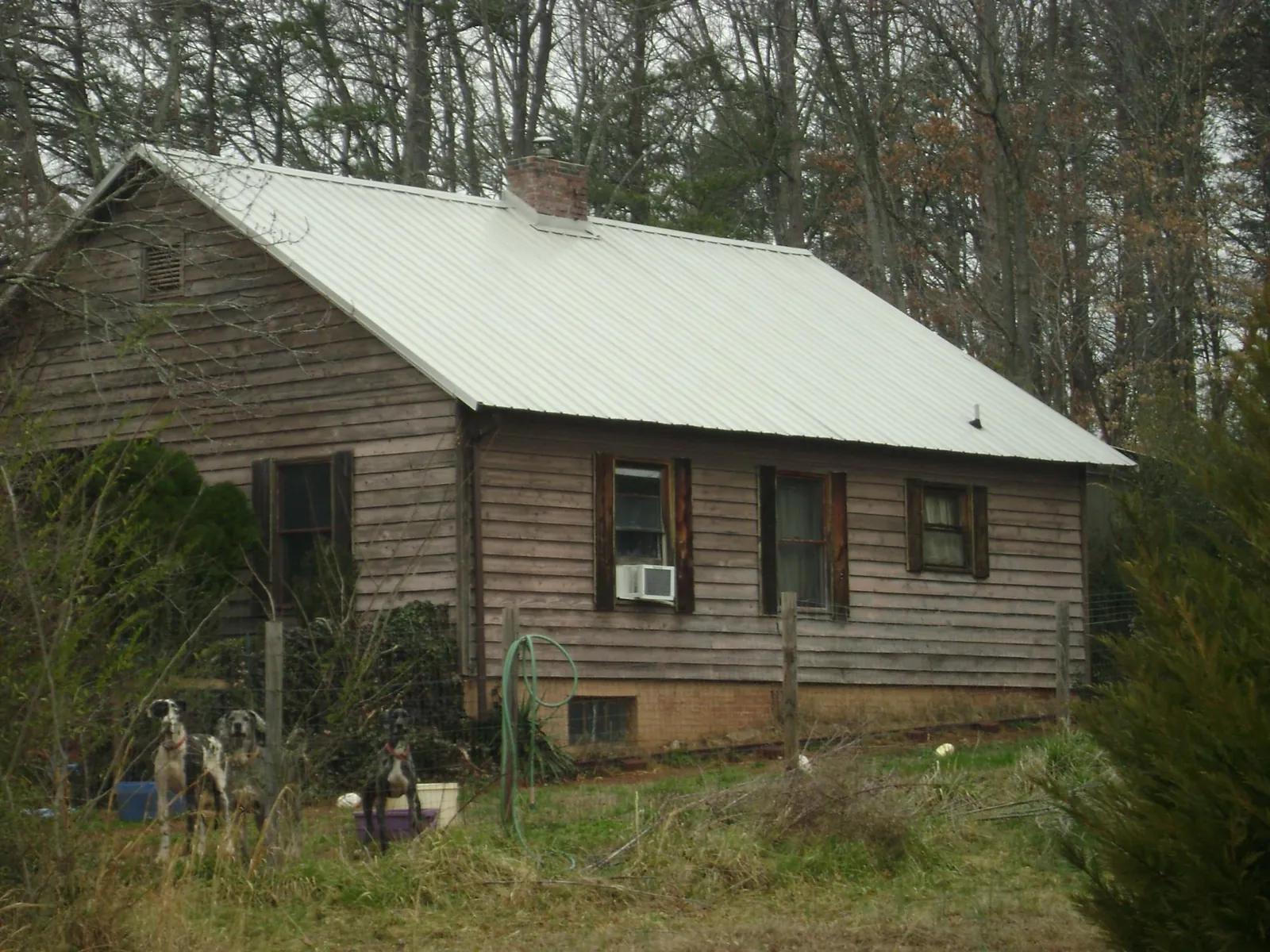 White metal roof on an old wood sided farmhouse, from a Asphalt Shingle Roof Repair job in North Oxford